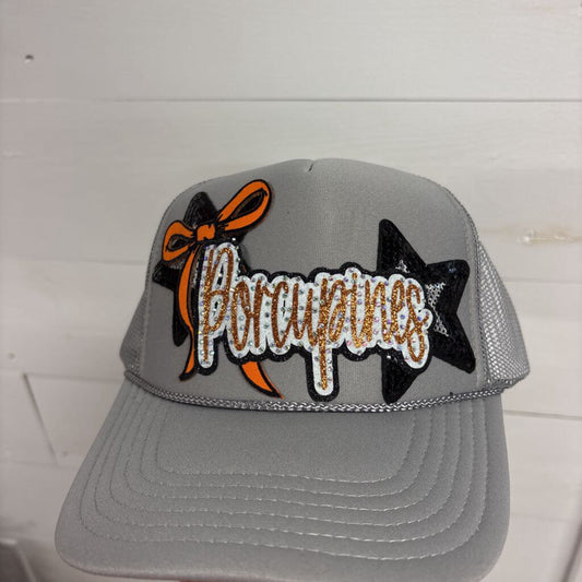Gray OTTO trucker with small rhinestone porcupine with slender orange bow and two black/ sliver stars