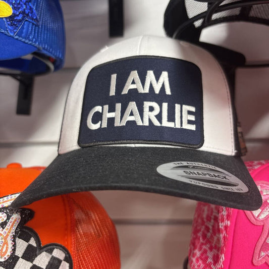 Black and white Yupoong hat with I Am Charlie patch